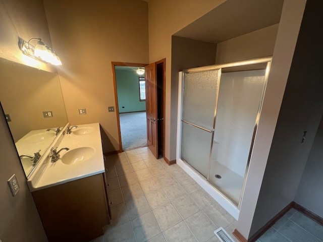 bathroom featuring vanity, tile patterned floors, and a shower with shower door