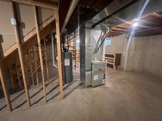 basement featuring heating unit and water heater