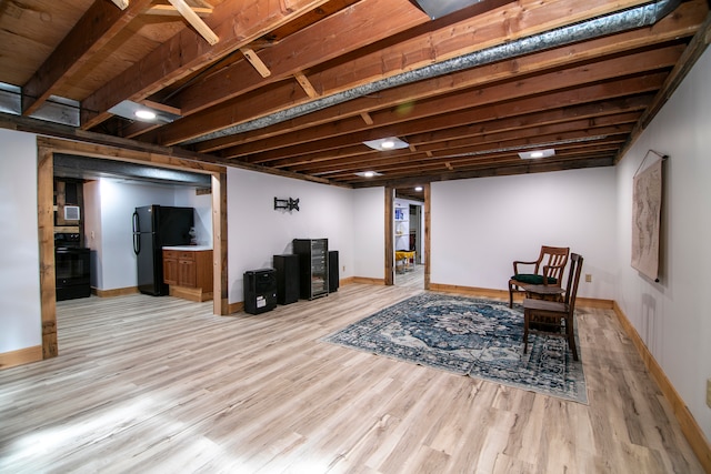 living area featuring beam ceiling and light wood-type flooring