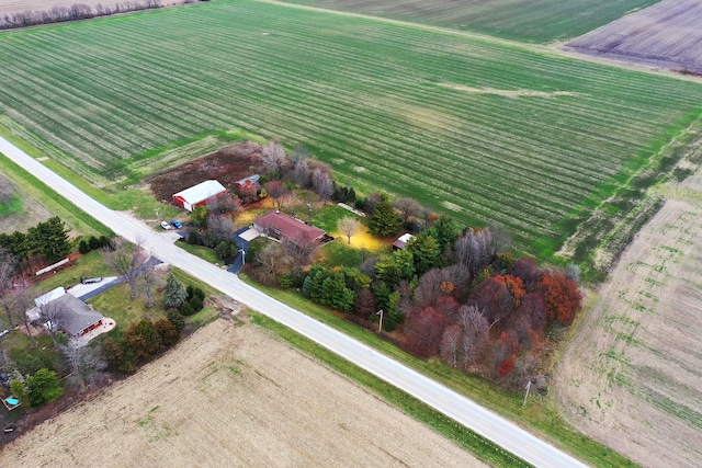 birds eye view of property with a rural view