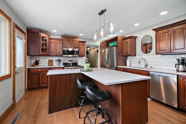 kitchen with a center island, sink, and stainless steel appliances