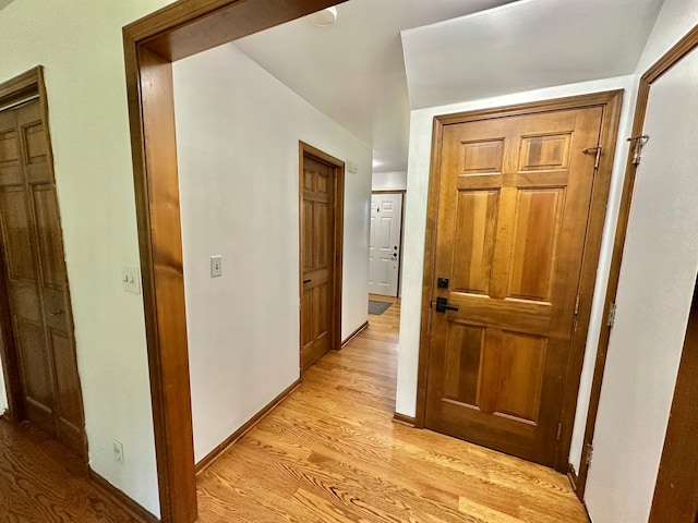 corridor with light wood-type flooring