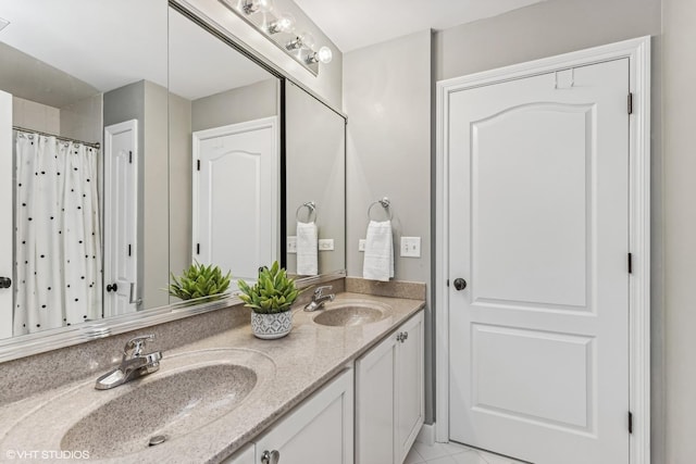 full bath with a sink and double vanity