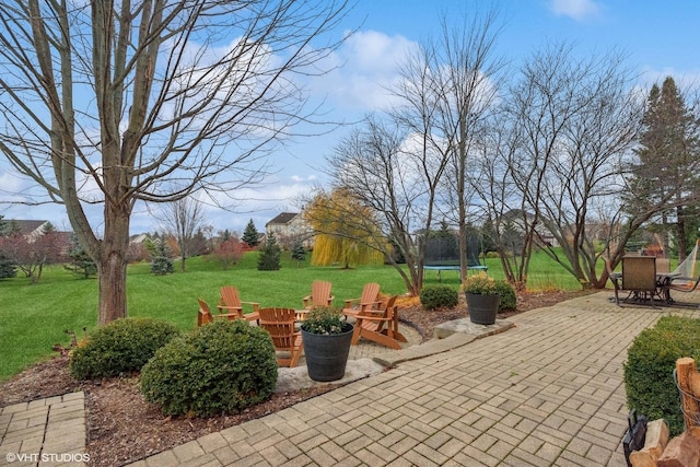 view of patio featuring a fire pit and a trampoline