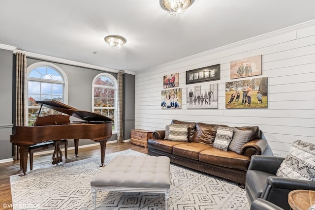 interior space featuring baseboards, wood finished floors, and crown molding