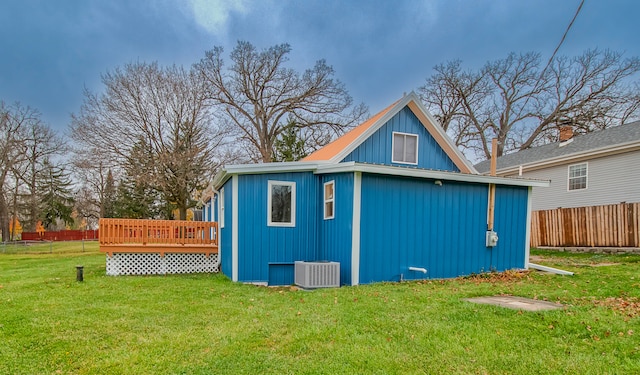 view of outbuilding featuring a yard and central air condition unit