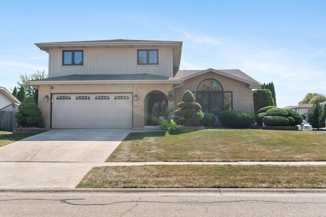 view of front facade featuring a front lawn and a garage