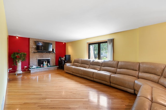 living room with a fireplace and wood-type flooring