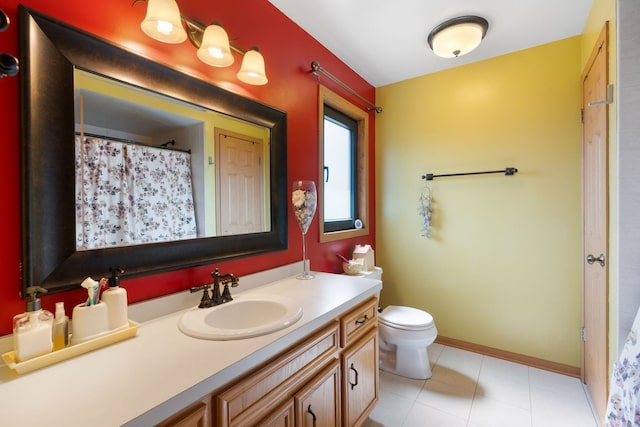 bathroom featuring tile patterned flooring, vanity, and toilet