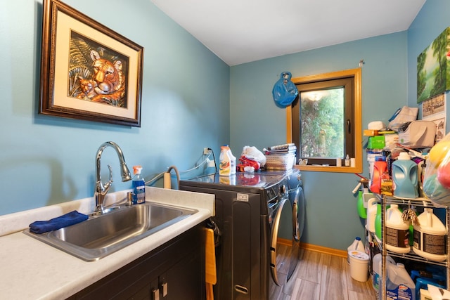 washroom featuring separate washer and dryer, sink, and hardwood / wood-style floors