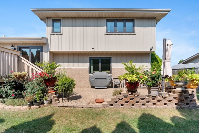 back of house featuring a yard and a patio area