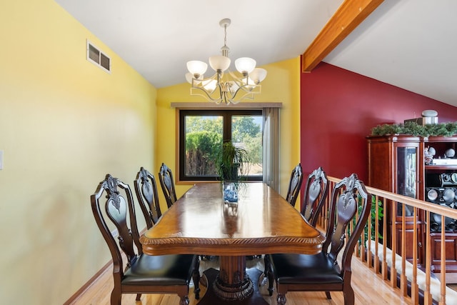 dining space with lofted ceiling with beams, a notable chandelier, and light wood-type flooring