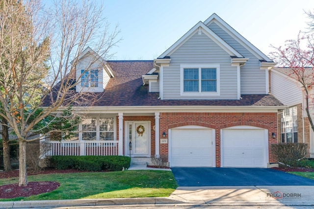 view of front of home featuring a front yard and a garage