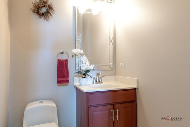 bathroom featuring vanity and toilet