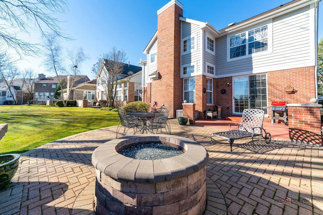 view of patio with an outdoor fire pit