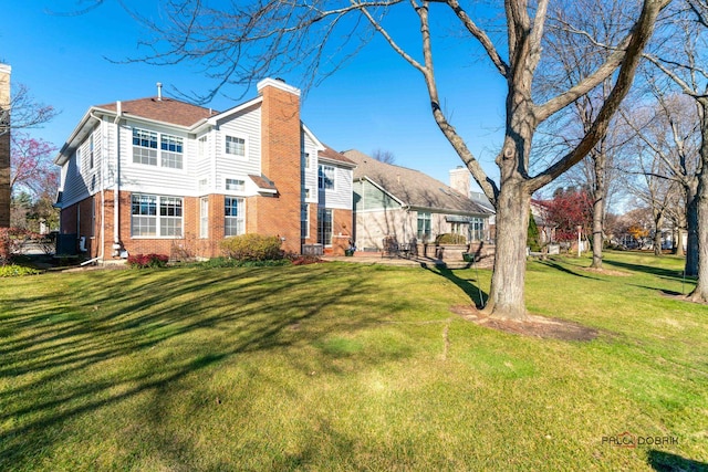 back of property featuring a lawn