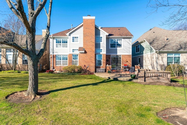 rear view of property with a yard and a patio