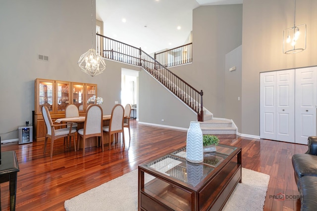 living room featuring dark hardwood / wood-style floors and high vaulted ceiling