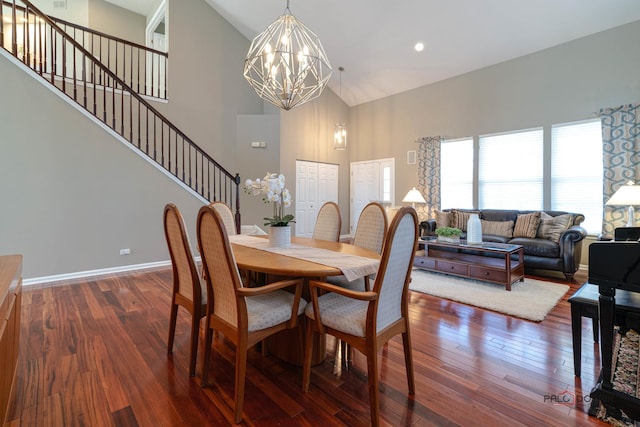 dining room with an inviting chandelier, dark hardwood / wood-style floors, and high vaulted ceiling