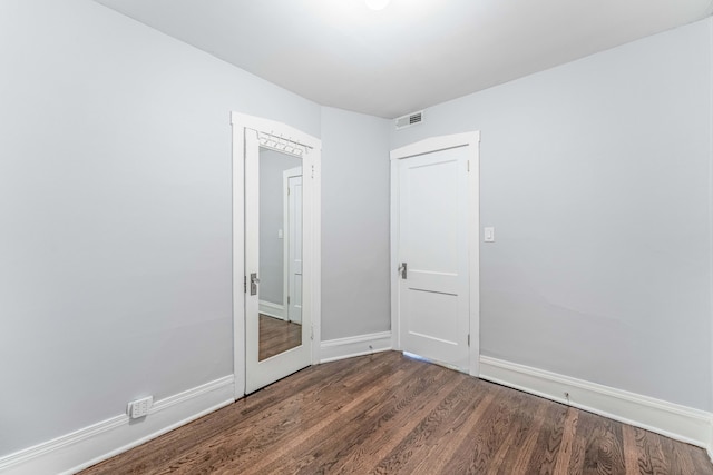 empty room featuring dark hardwood / wood-style flooring