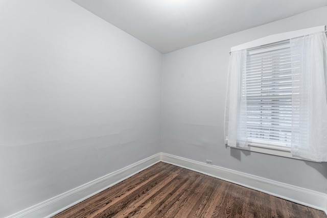 unfurnished room featuring dark hardwood / wood-style flooring