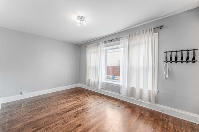 empty room with dark wood-type flooring