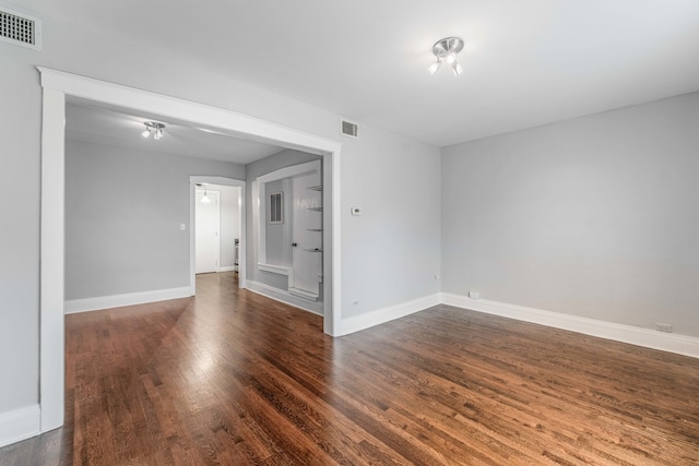 empty room with dark hardwood / wood-style floors