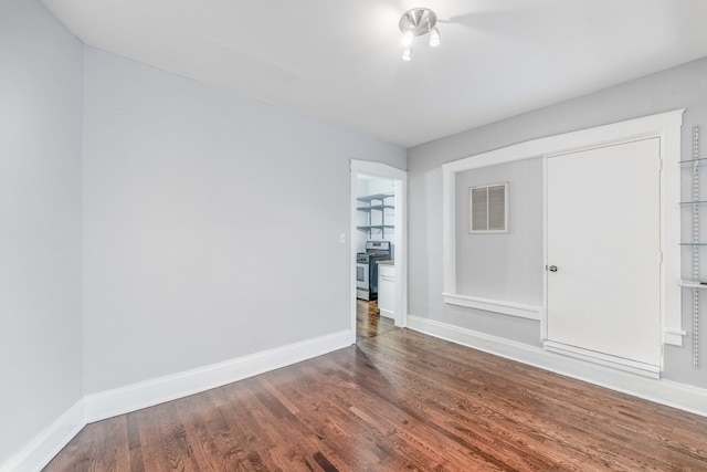 empty room with dark hardwood / wood-style floors