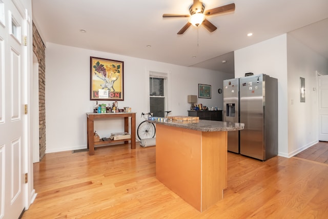 kitchen with ceiling fan, light hardwood / wood-style floors, and stainless steel refrigerator with ice dispenser