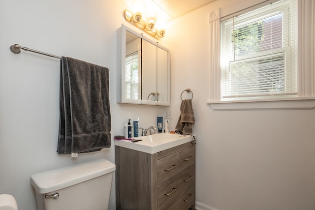 bathroom featuring vanity and toilet