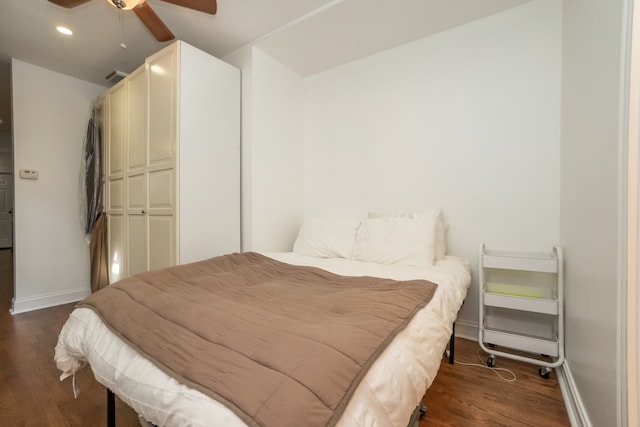 bedroom featuring ceiling fan, a closet, and dark hardwood / wood-style floors