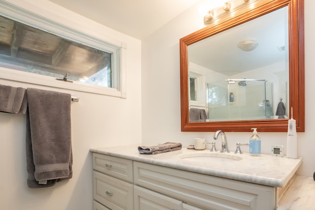 bathroom featuring vanity and an enclosed shower