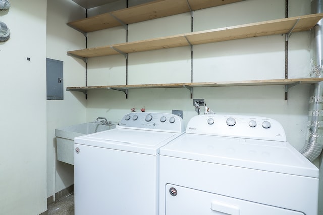 washroom with washer and clothes dryer and electric panel