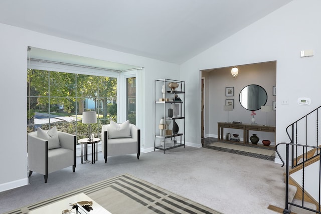 living area featuring carpet floors and lofted ceiling