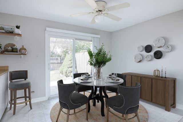 tiled dining area with ceiling fan