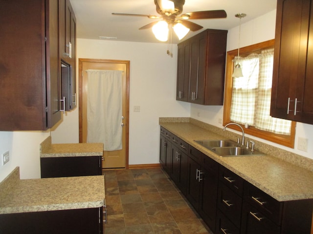 kitchen featuring pendant lighting, ceiling fan, and sink