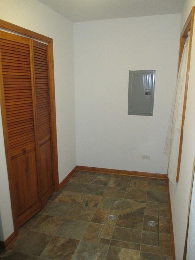 unfurnished bedroom featuring electric panel and a closet