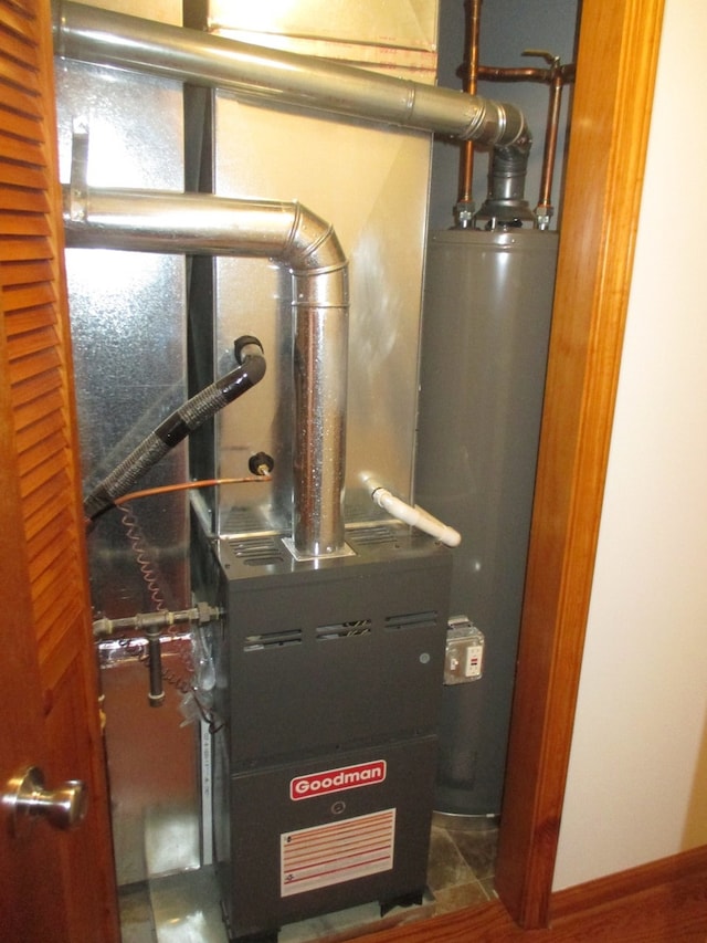 utility room featuring gas water heater