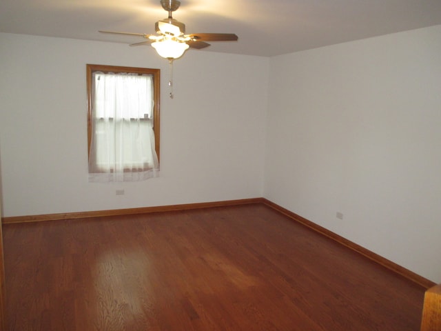 spare room with ceiling fan and wood-type flooring