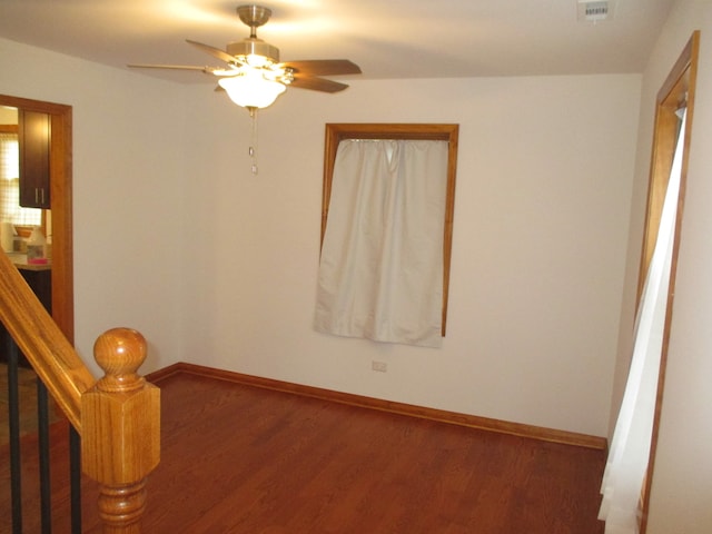 empty room with ceiling fan and wood-type flooring