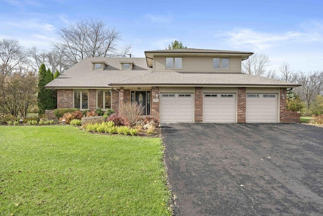 view of front of house featuring a front lawn and a garage