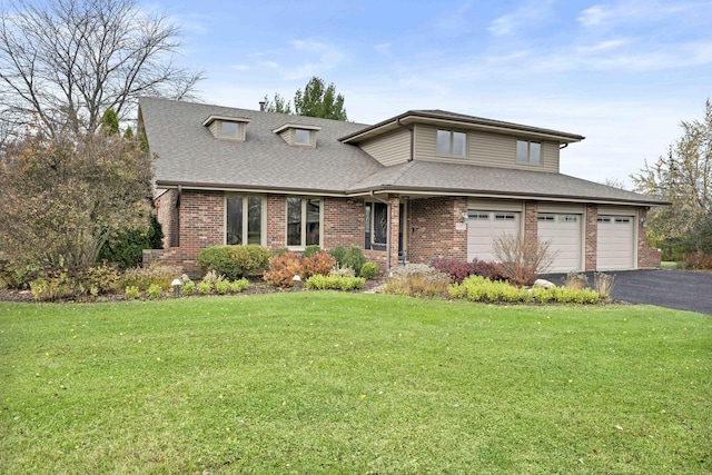 view of front of home with a front yard and a garage