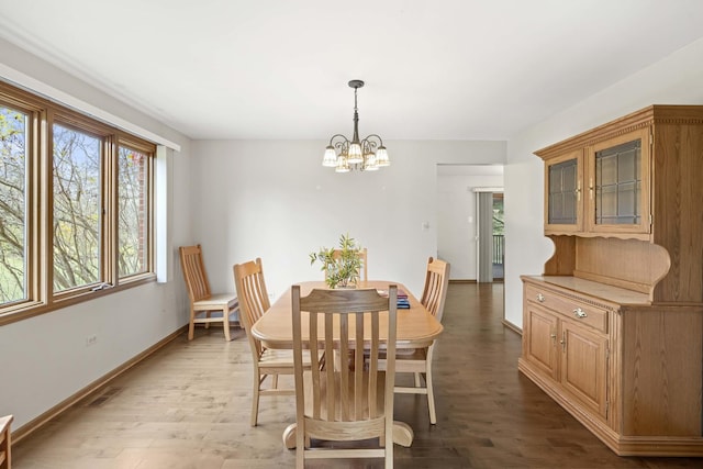 dining room with hardwood / wood-style flooring and a notable chandelier