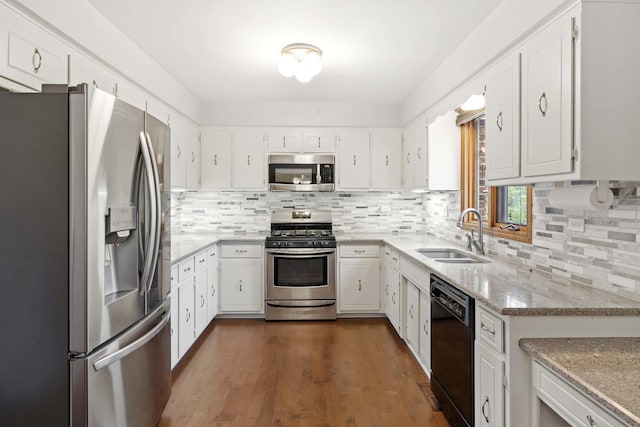 kitchen with sink, white cabinets, dark wood-type flooring, and appliances with stainless steel finishes