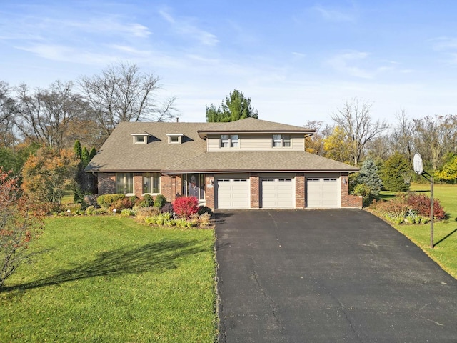 view of front of house with a front yard and a garage