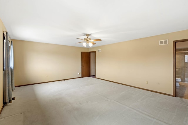 empty room featuring light colored carpet and ceiling fan