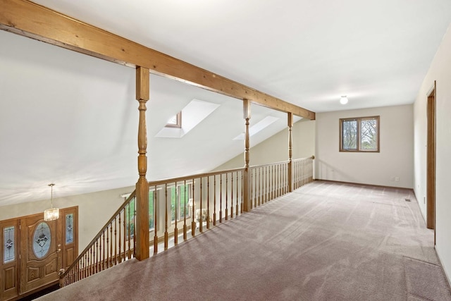 additional living space featuring carpet and lofted ceiling with beams