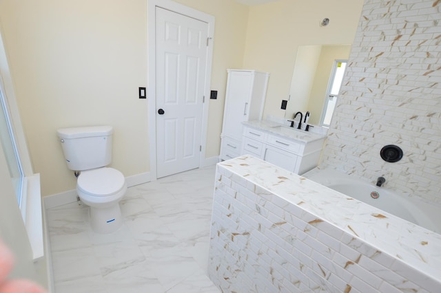 full bath featuring vanity, a bathing tub, baseboards, toilet, and marble finish floor