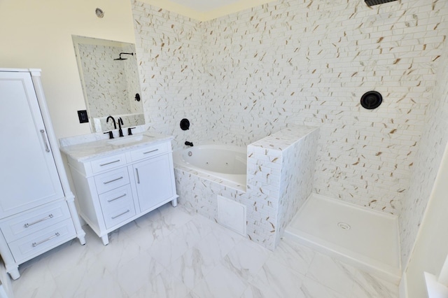 full bathroom featuring marble finish floor, a jetted tub, tiled shower, and vanity