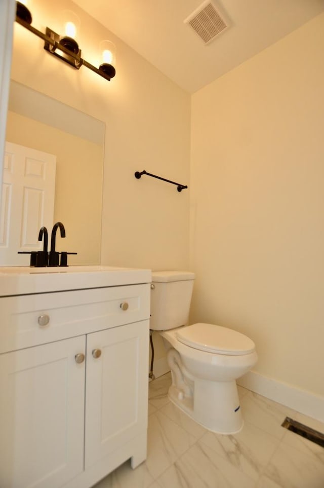 bathroom with visible vents, toilet, marble finish floor, baseboards, and vanity